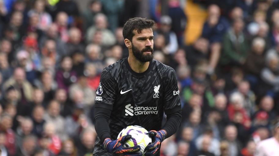 Alisson prepares to kick the ball during a Liverpool game.