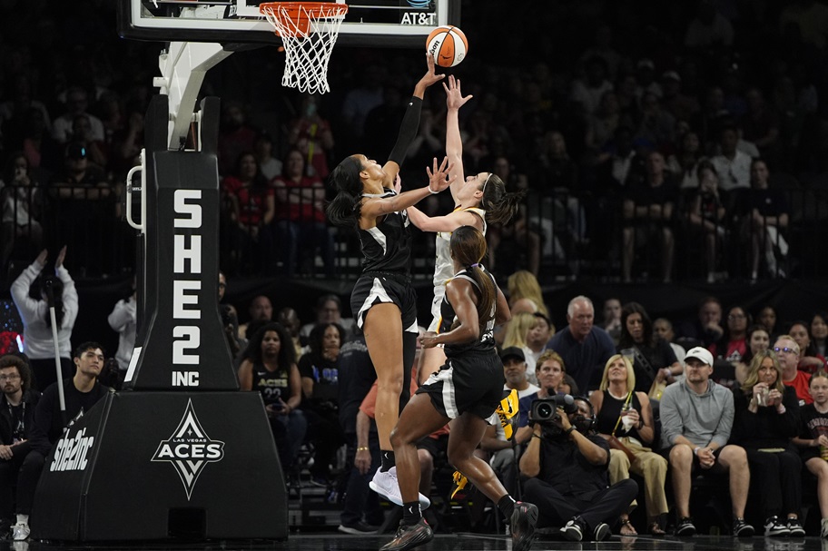 A'ja Wilson blocks a shot by Caitlin Clark