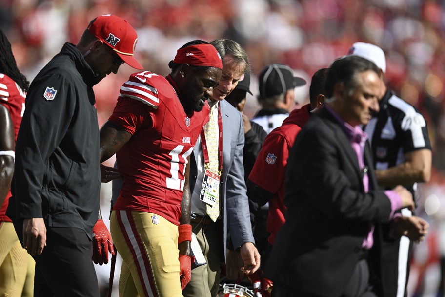 Brandon Aiyuk walks off the field after an injury.