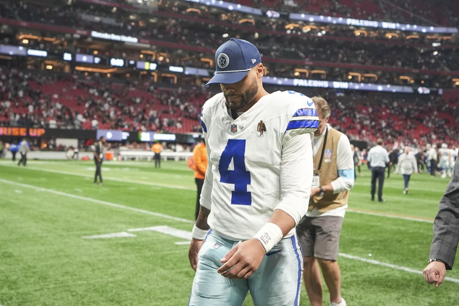 Dak Prescott walks off the field after a loss to Atlanta.